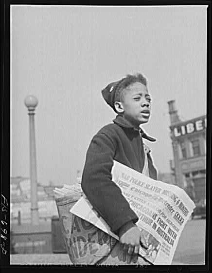 Boy selling Chicago Defender, 1942