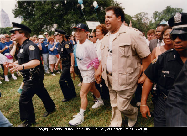 Singer/Songwriter Elton John and Atlanta Mayor Maynard Jackson in AIDS walk, Piedmont Park, Atlanta, Georgia, July 1991. 