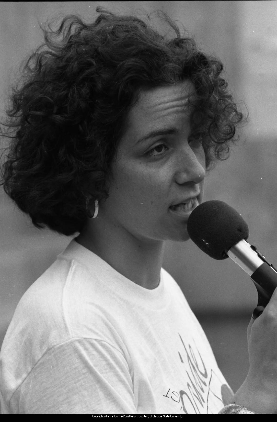 Woman at microphone, 1980 gay pride celebration, Atlanta, Georgia, June 21, 1980.
