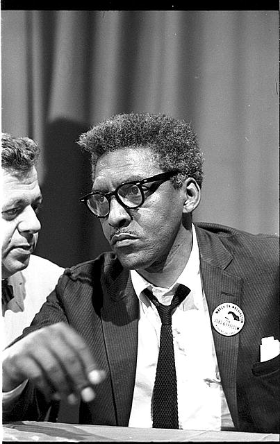 photo, Bayard Rustin at news briefing on the Civil Rights March on Washington in the Statler Hotel, half-length portrait, seated at table