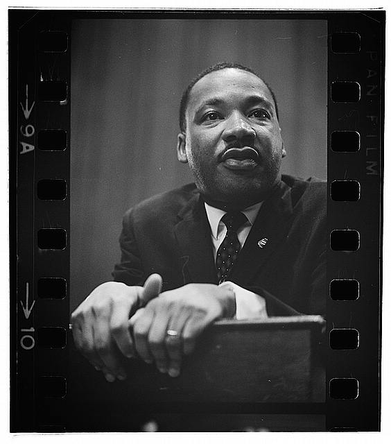 image of King leaning on a lectern, Martin Luther King Press Conference, March 26 1964