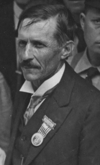 Close-up of stone cutter wearing ribbon