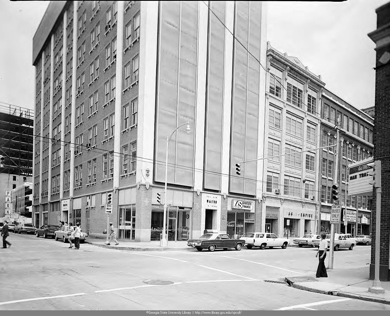Black and white photograph of a multi-story building on a city corner