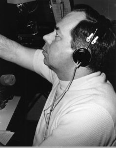 Station president Don Kennedy reading a morning broadcast for the Georgia Network