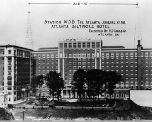 Two WSB radio antenna towers on the roof of the Atlanta Biltmore Hotel.  Writing on the photo gives the span between the towers as 312 feet and 6 inches, and also reads:  Station WSB, The Atlanta Journal at the Atlanta Biltmore Hotel, erected by H. J. Carr & Co., Atlanta, GA.