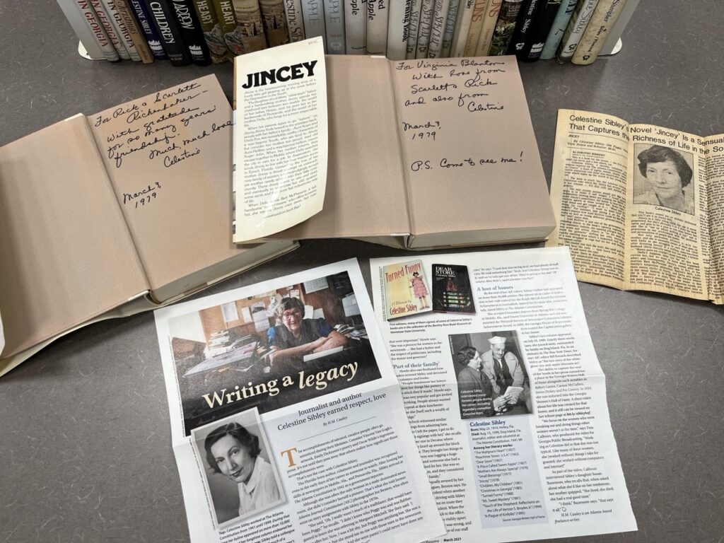 Newspaper clippings about author Celestine Sibley alongside autographed copies of books she wrote.